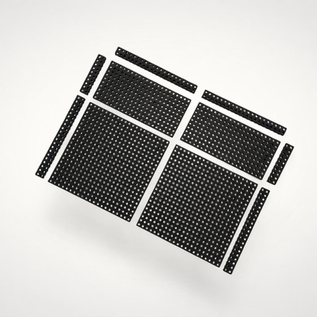 Complete arrangement of black perforated Base Modules in multiple sizes, designed to create a customisable foundation across the bottom of a drawer.