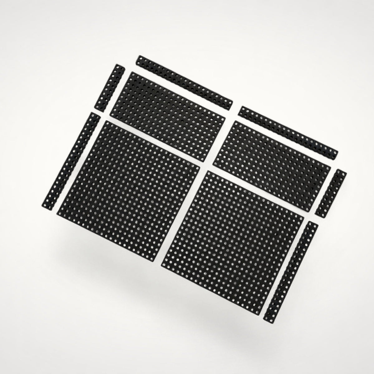 Complete arrangement of black perforated Base Modules in multiple sizes, designed to create a customisable foundation across the bottom of a drawer.