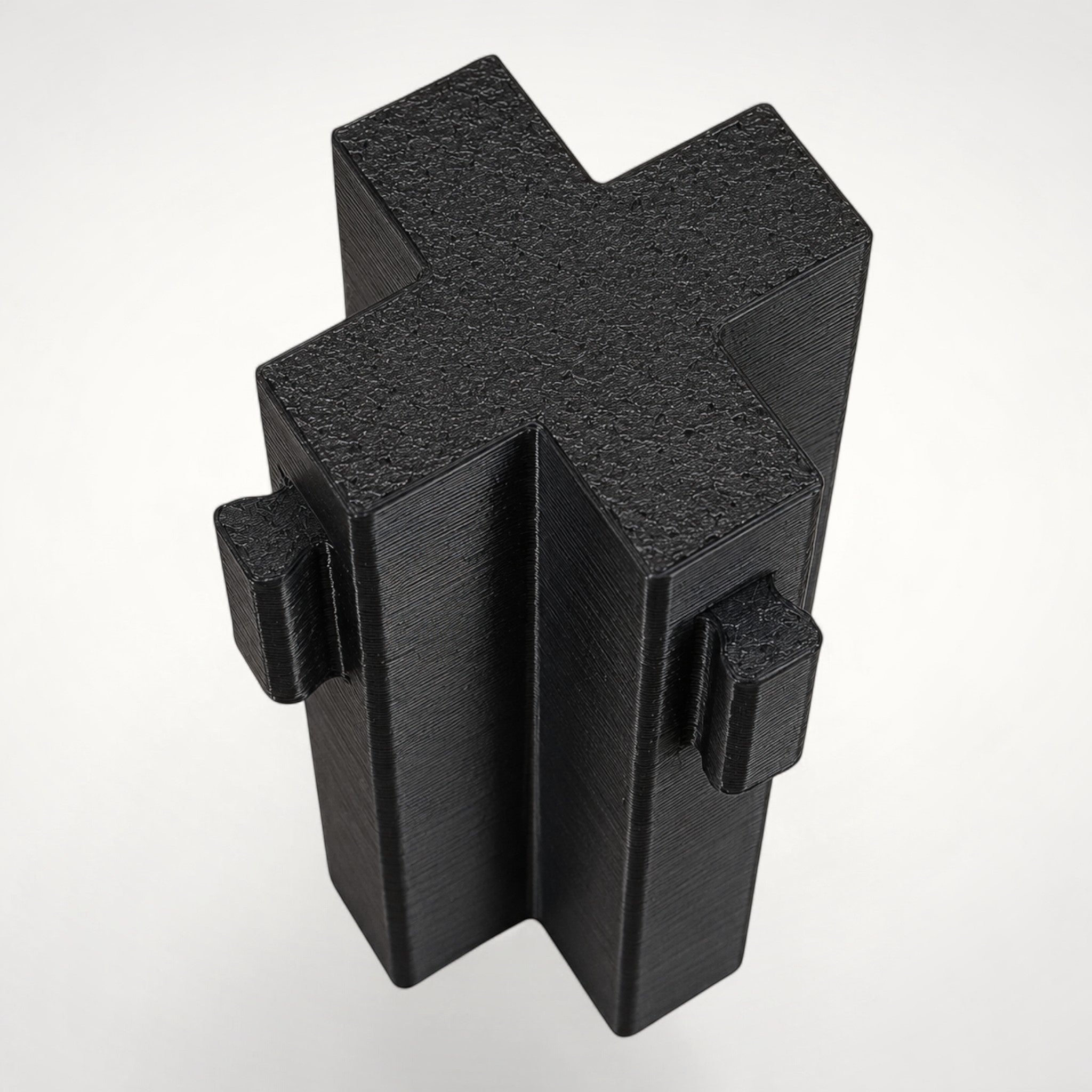 NG Organisers black cross-shaped wall module for drawer divider systems with four-way connection points.