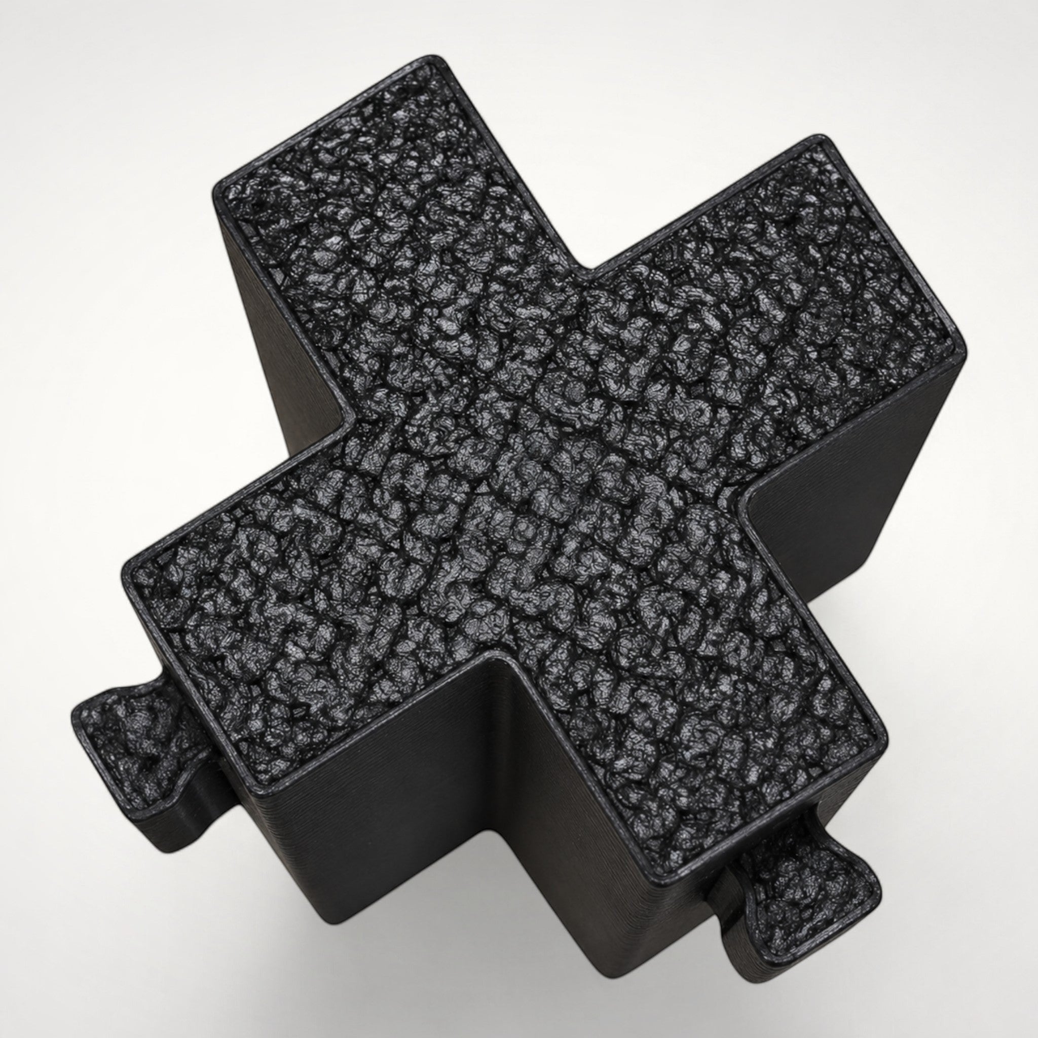 NG Organisers black cross-shaped wall module for drawer divider systems with a textured top surface