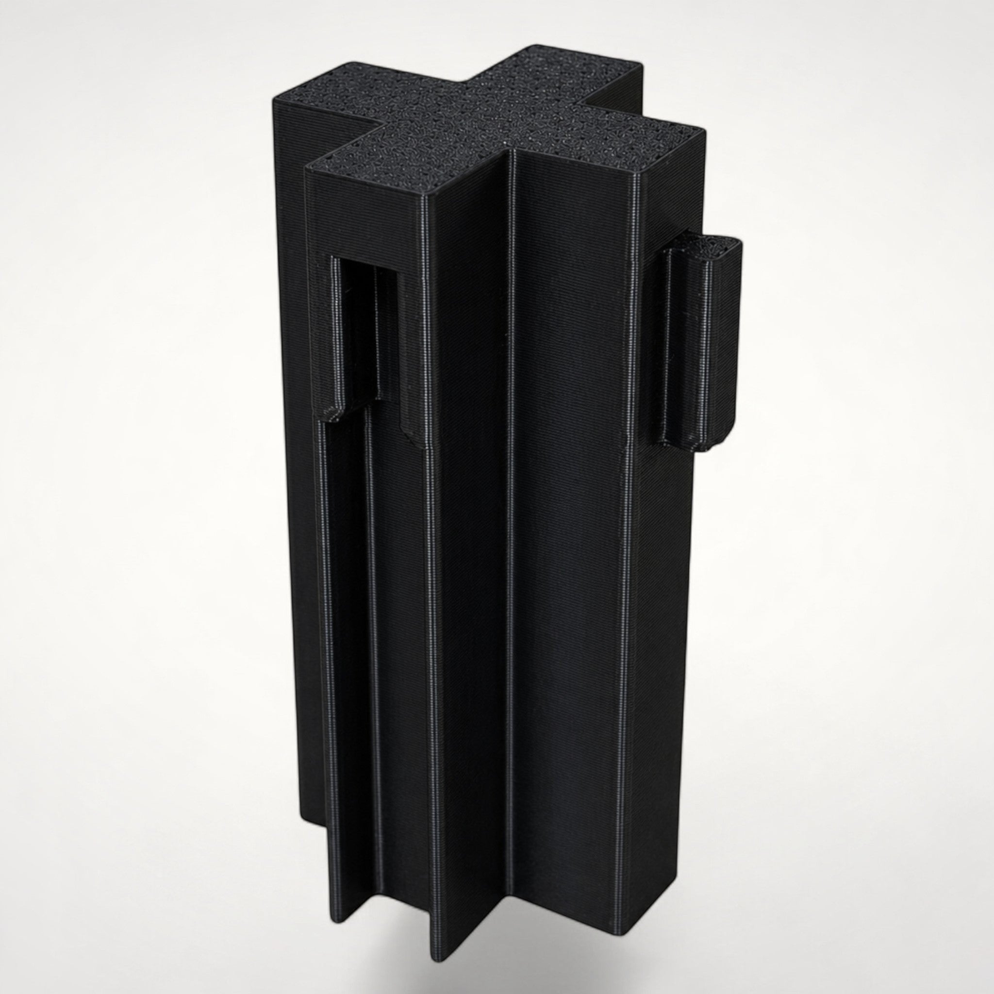 NG Organisers black cross-shaped wall module for drawer divider systems with four-way connection points.