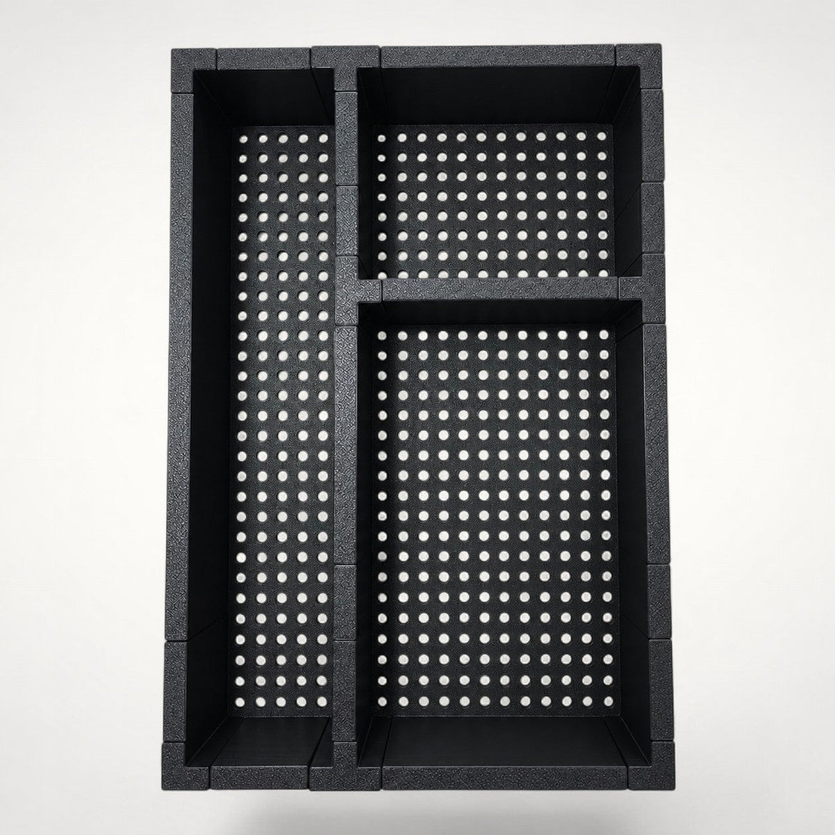 NG Organisers black dental hygiene drawer organiser with three compartments and a perforated base design.