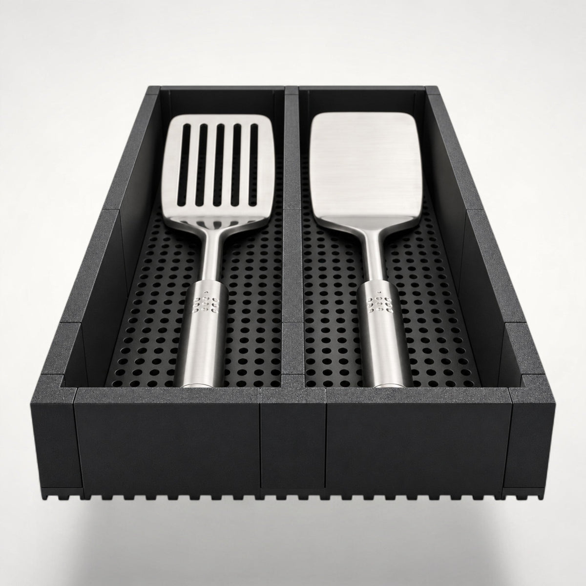 NG Organisers matte charcoal kitchen utensil drawer insert with two compartments and a perforated non-slip base.