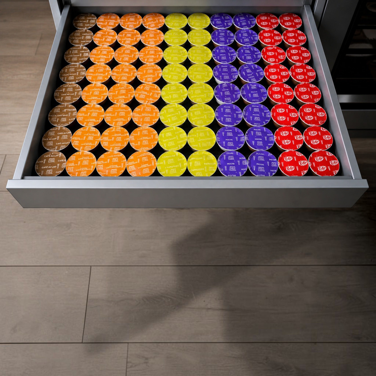 NG Organisers drawer insert filled with colourful Dolce Gusto coffee pods arranged in neat rows for kitchen storage