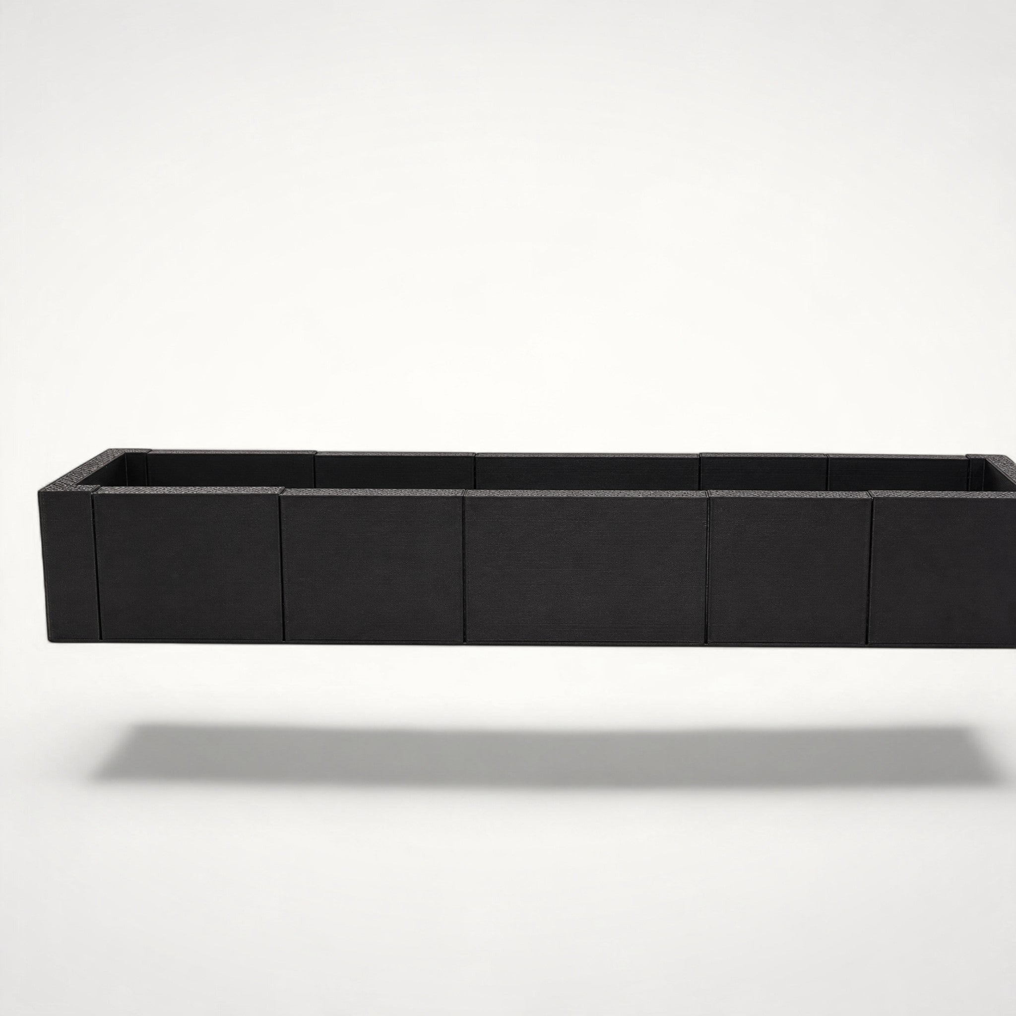 NG Organisers modular black storage box for drawers with an elongated, seven-piece assembly design.