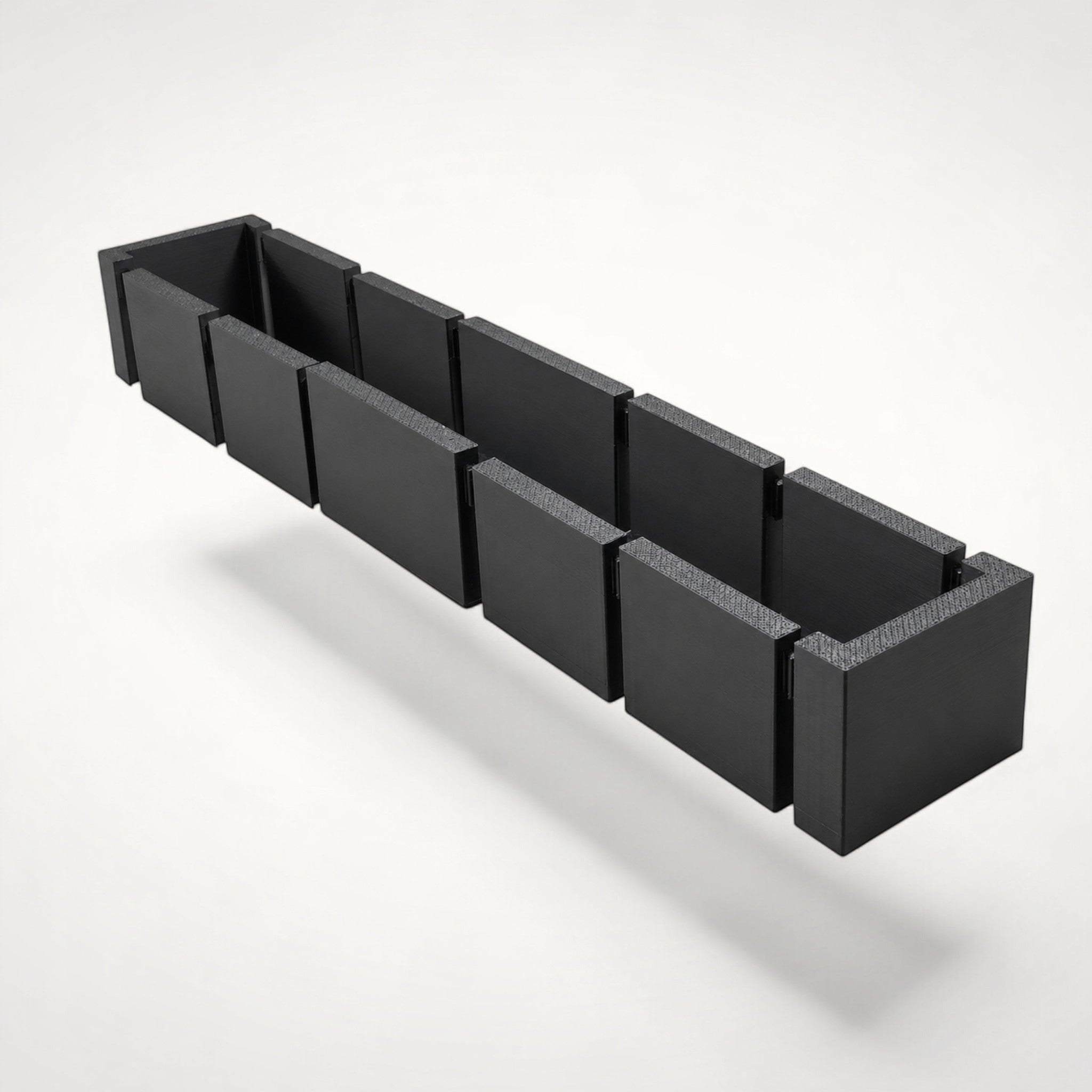 NG Organisers modular black storage box insert for drawers, featuring a long, narrow, seven-piece assembly design.