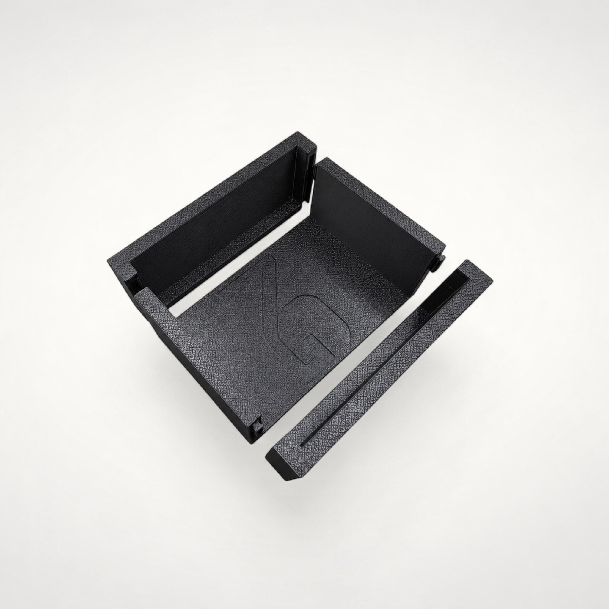 NG Organisers modular black storage box insert with branded base and separate edge components on a white background.