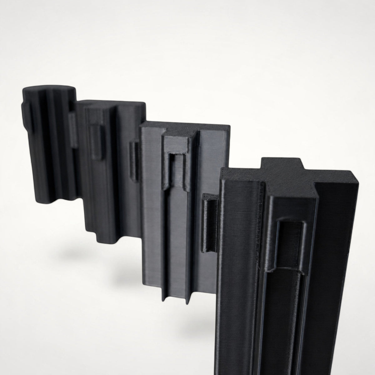 NG Organisers black T-shaped plastic wall module for drawer divider systems with double male connection points.